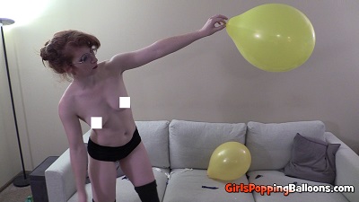 girl popping balloons